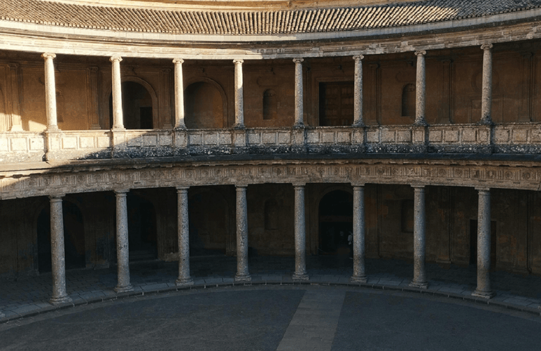 Circular courtyard with stone columns and two levels.