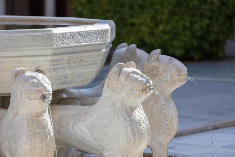 Stone fountain with lion sculptures spouting water