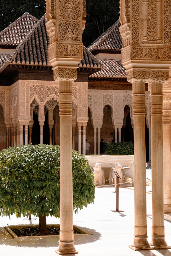 Ornate Moorish architecture with columns and lush greenery.